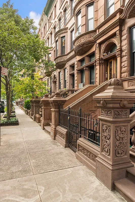 Brownstone row and stoops along West 121st Street in Harlem