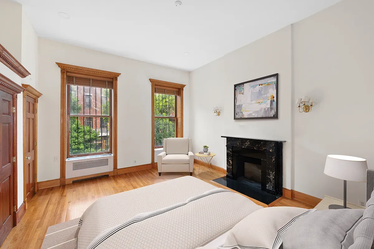 Virtually staged bedroom with marble fireplace at 14 West 121st Street