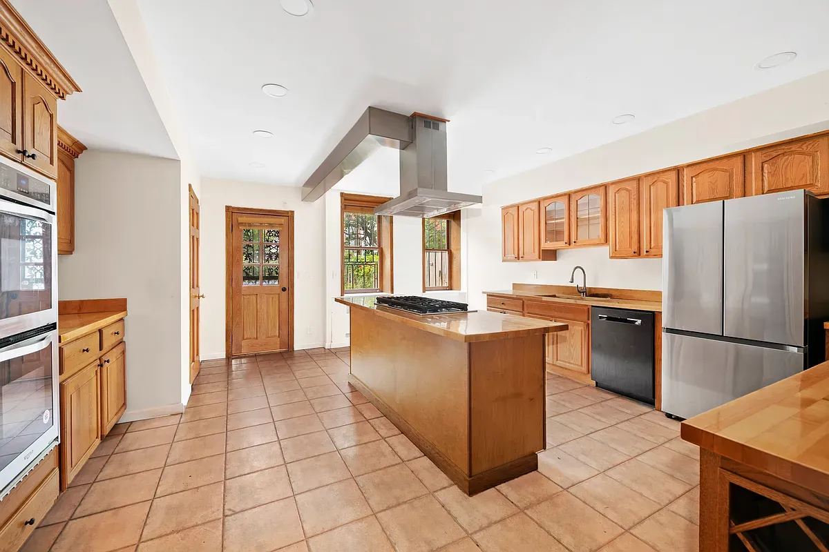 Kitchen with center island and tile floor at 14 West 121st Street