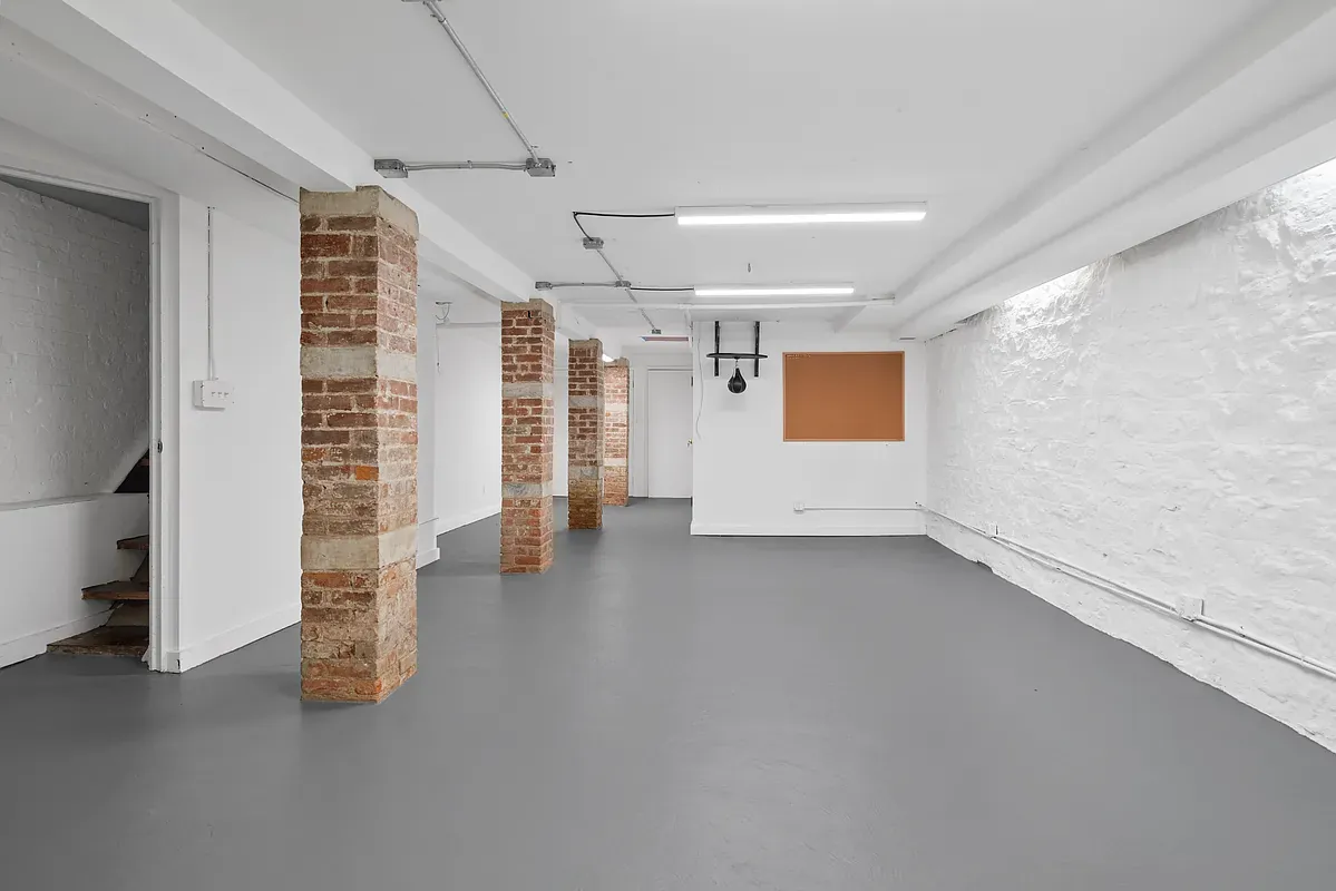 Open lower level with brick columns at 14 West 121st Street