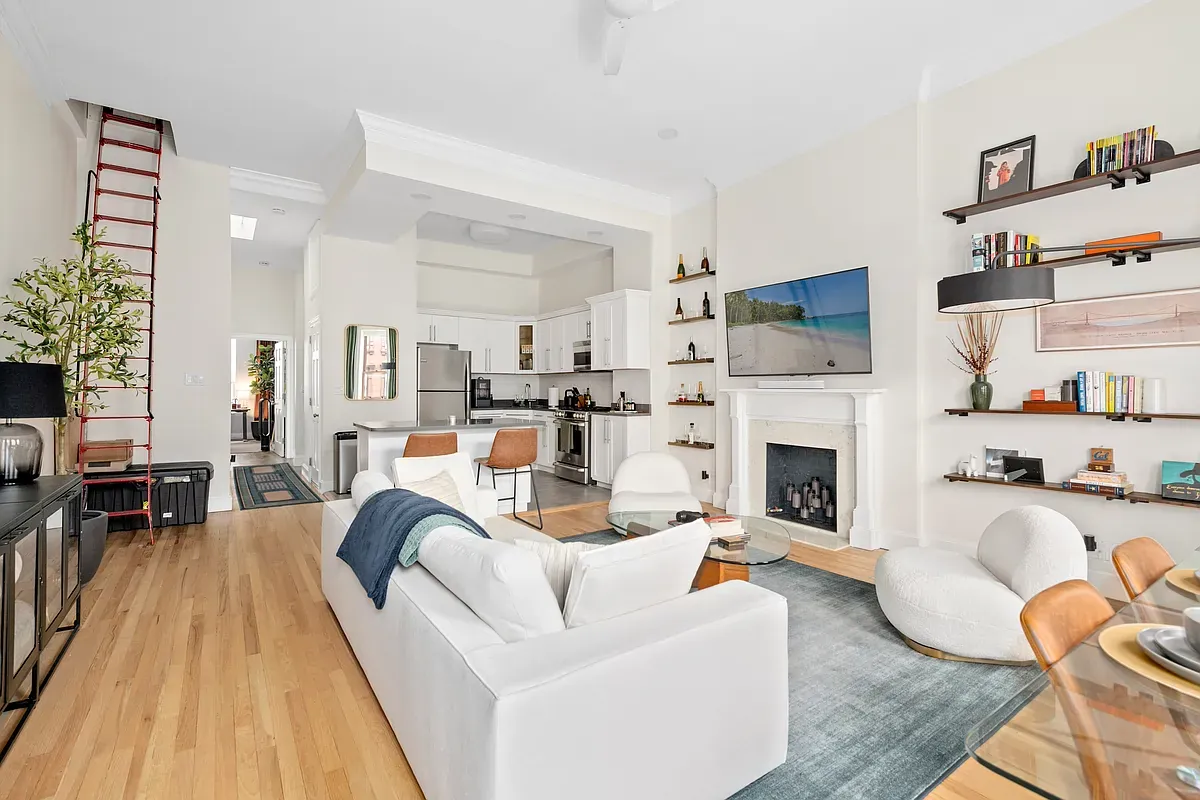 Open living room and kitchen with built-in shelving at 14 West 121st Street