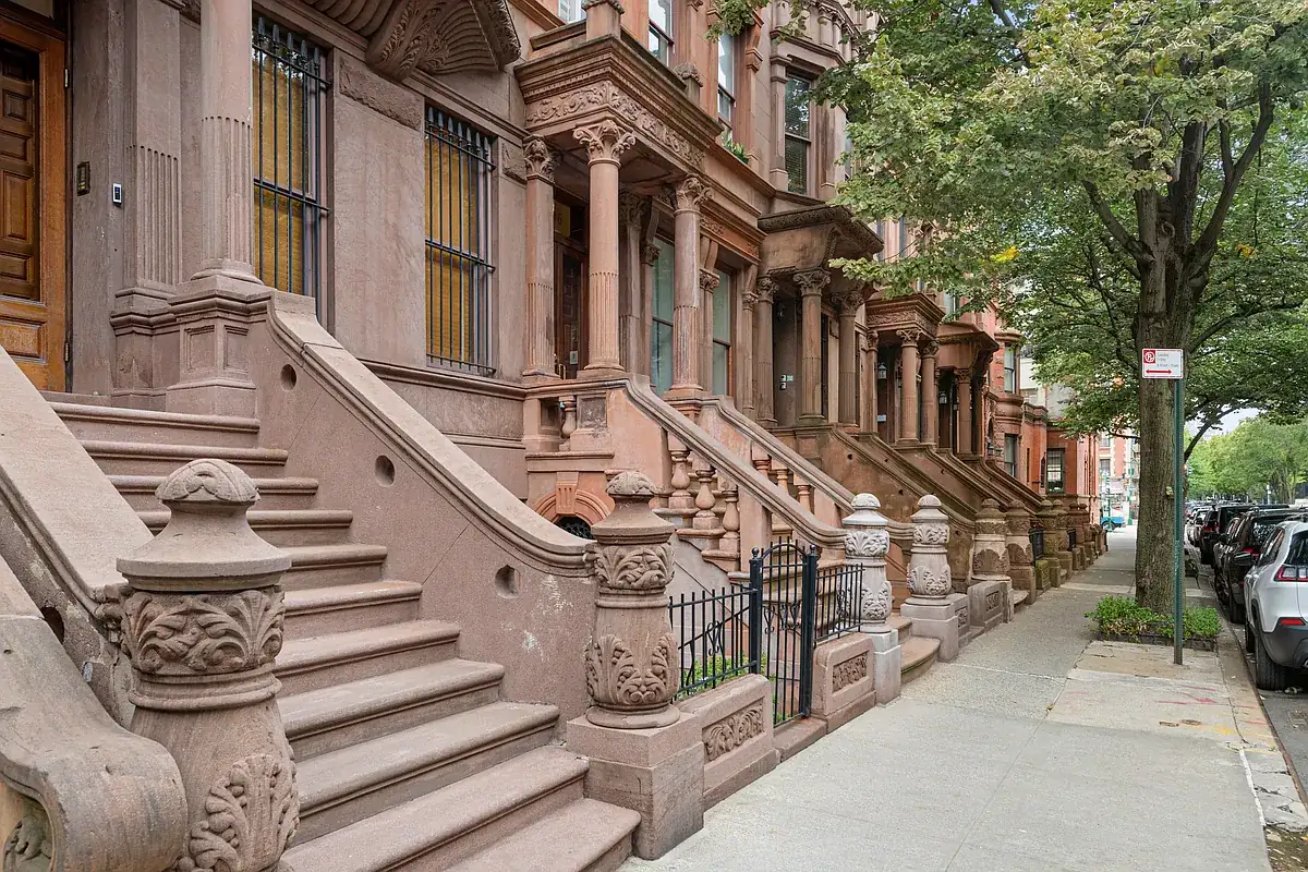 Stoop and brownstone block on West 121st Street in Harlem