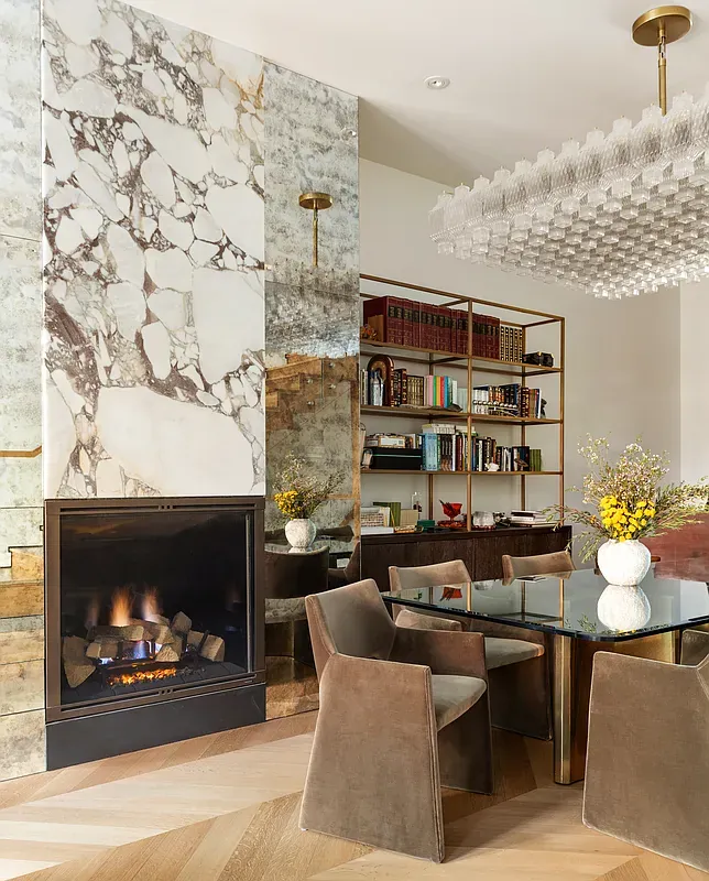 Dining room with fireplace and built-in bookshelves at 26 West 95th Street
