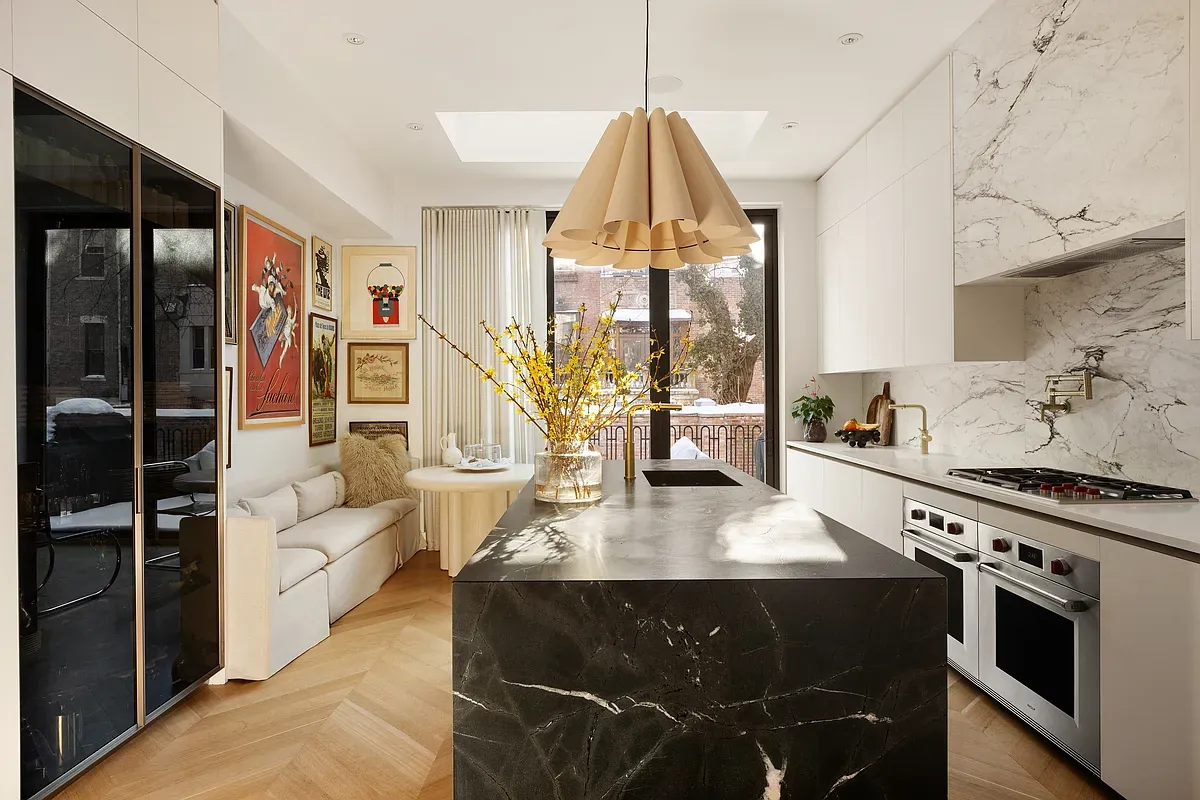 Kitchen with marble island and skylight at 26 West 95th Street