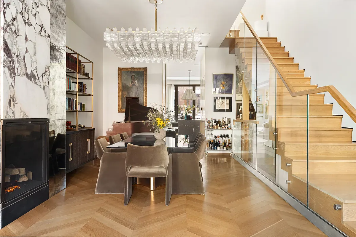 Parlor floor with dining room, fireplace and staircase at 26 West 95th Street