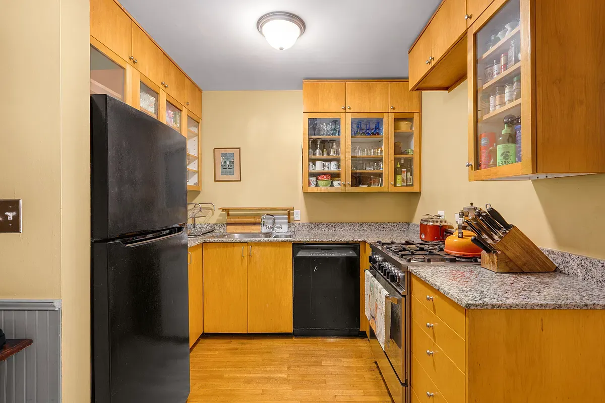 Kitchen with wood cabinets and stone counters at 306 West 90th Street #1