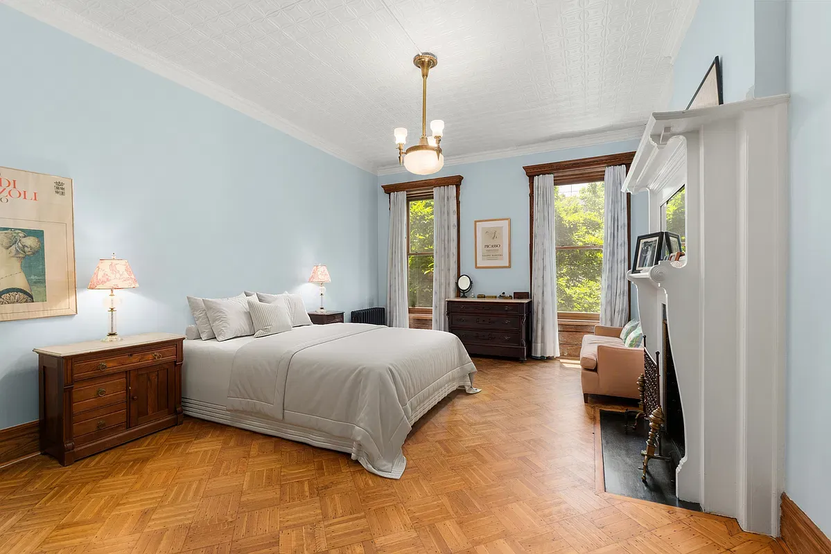 Bedroom with fireplace and garden views at 360 West 121st Street