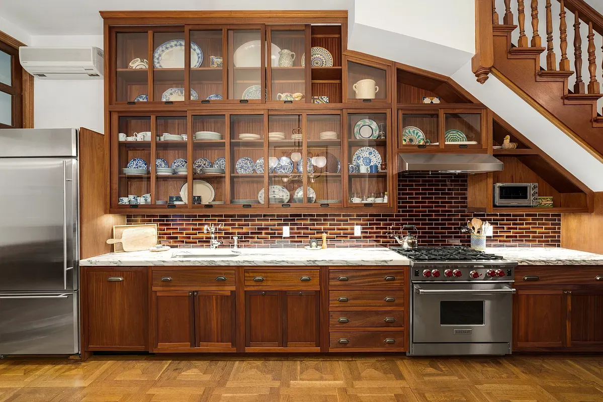 Kitchen with glass-front china cabinets at 360 West 121st Street