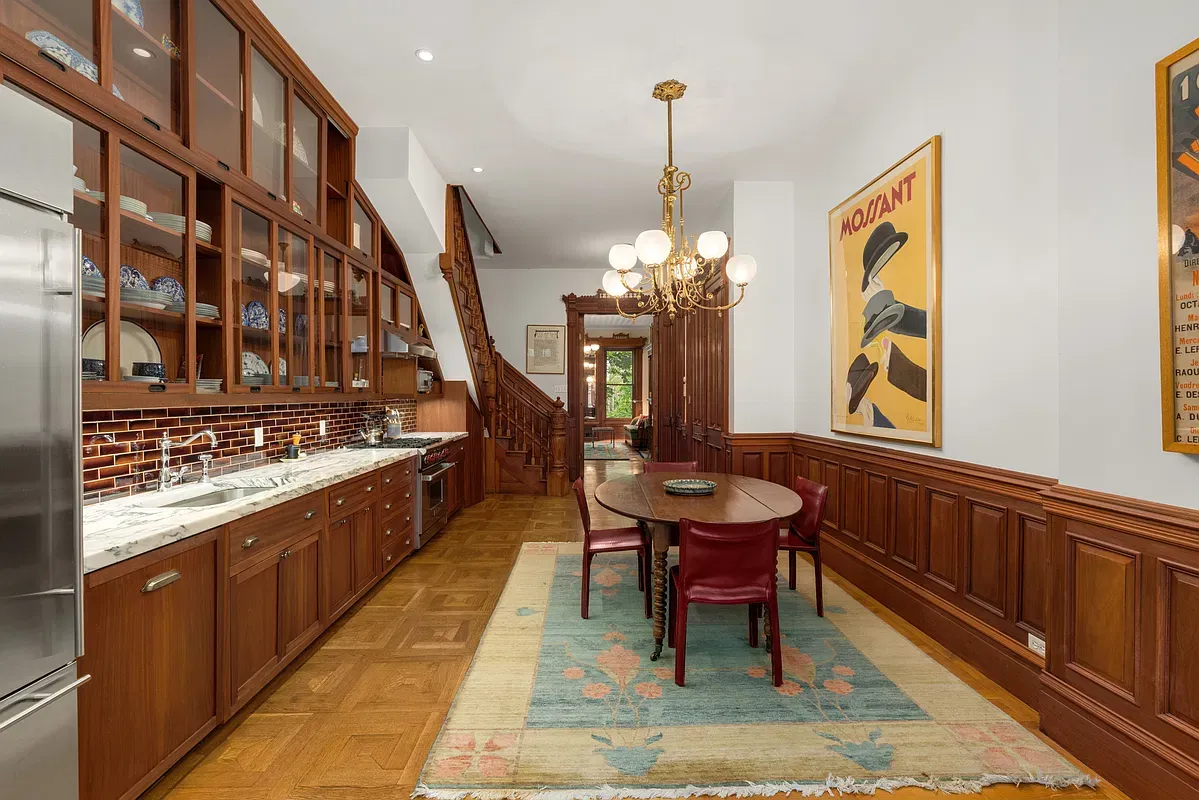Kitchen and dining room with wood cabinetry at 360 West 121st Street