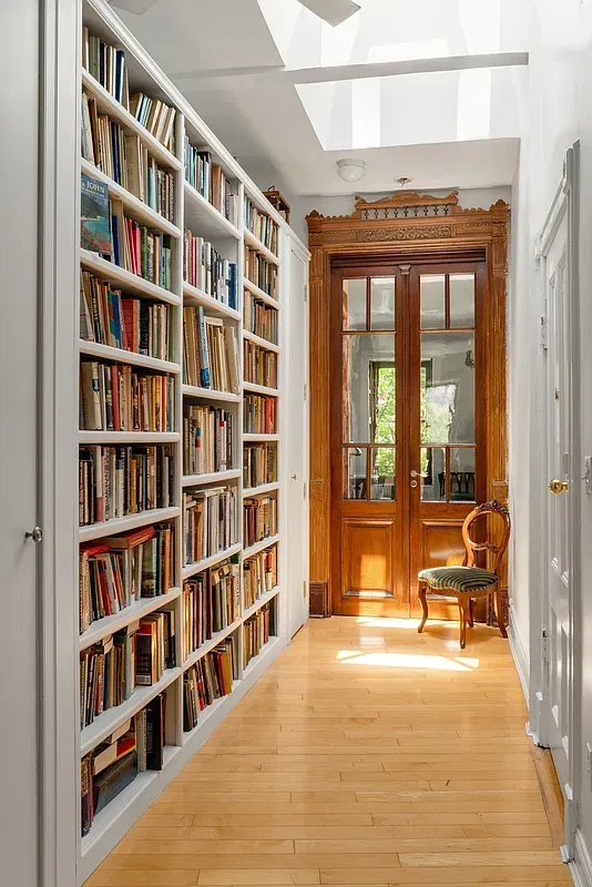 Hall lined with built-in bookshelves at 360 West 121st Street