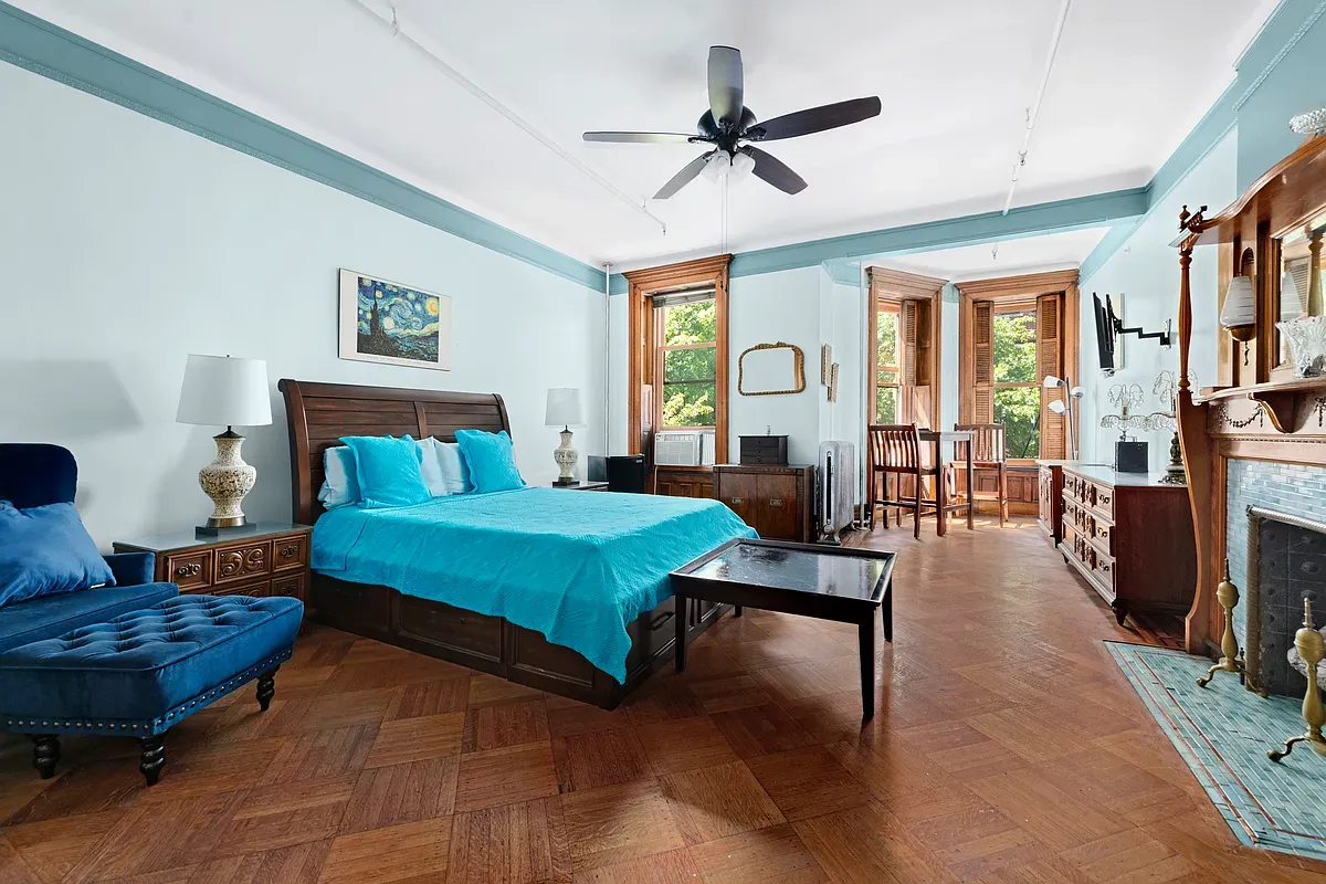 Large bedroom with fireplace and pier mirror at 475 West 144th Street