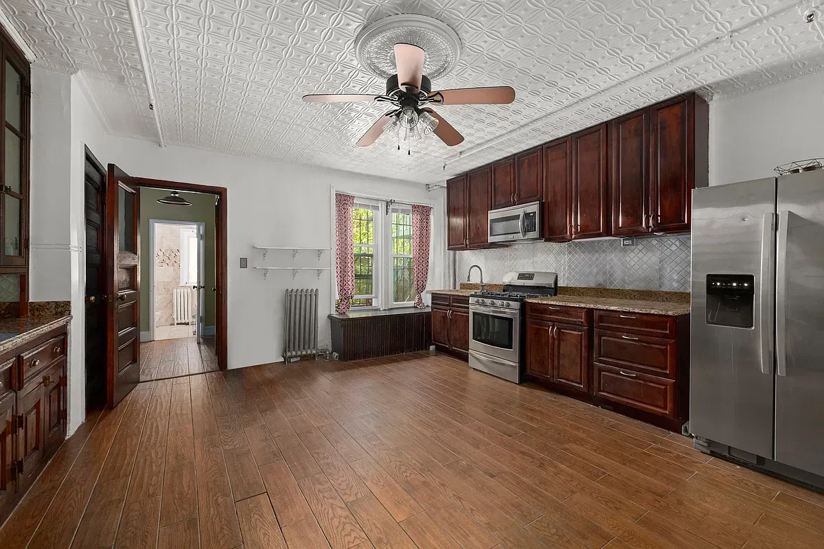 Kitchen with wood cabinets and stainless appliances at 475 West 144th Street