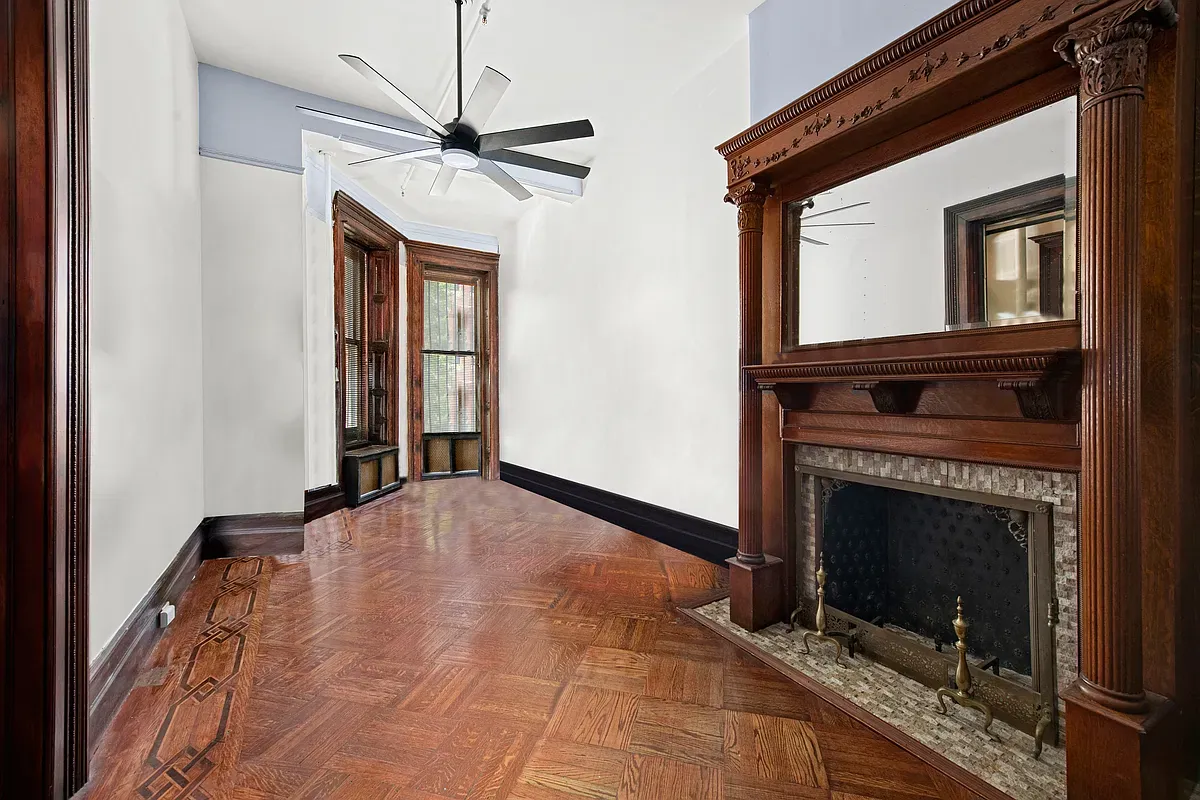 Parlor room with carved mantel and mirror at 475 West 144th Street