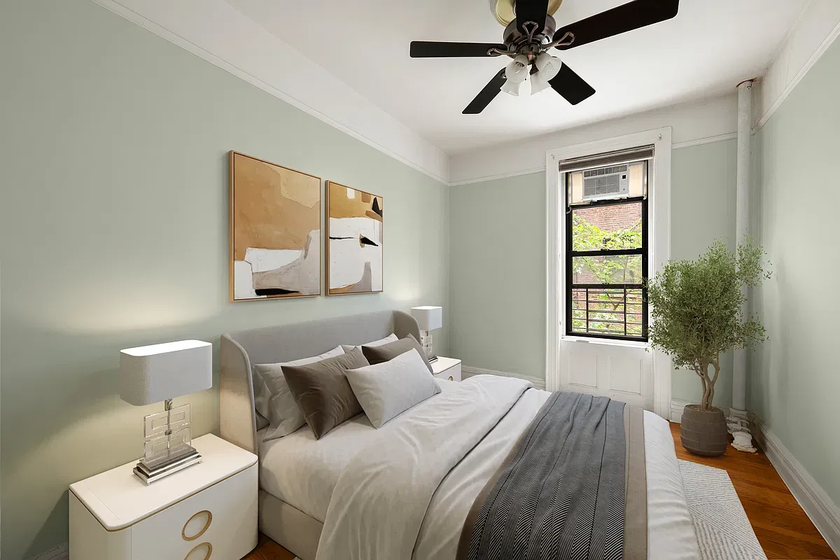 Virtually staged bedroom with ceiling fan at 523 West 121st Street #2