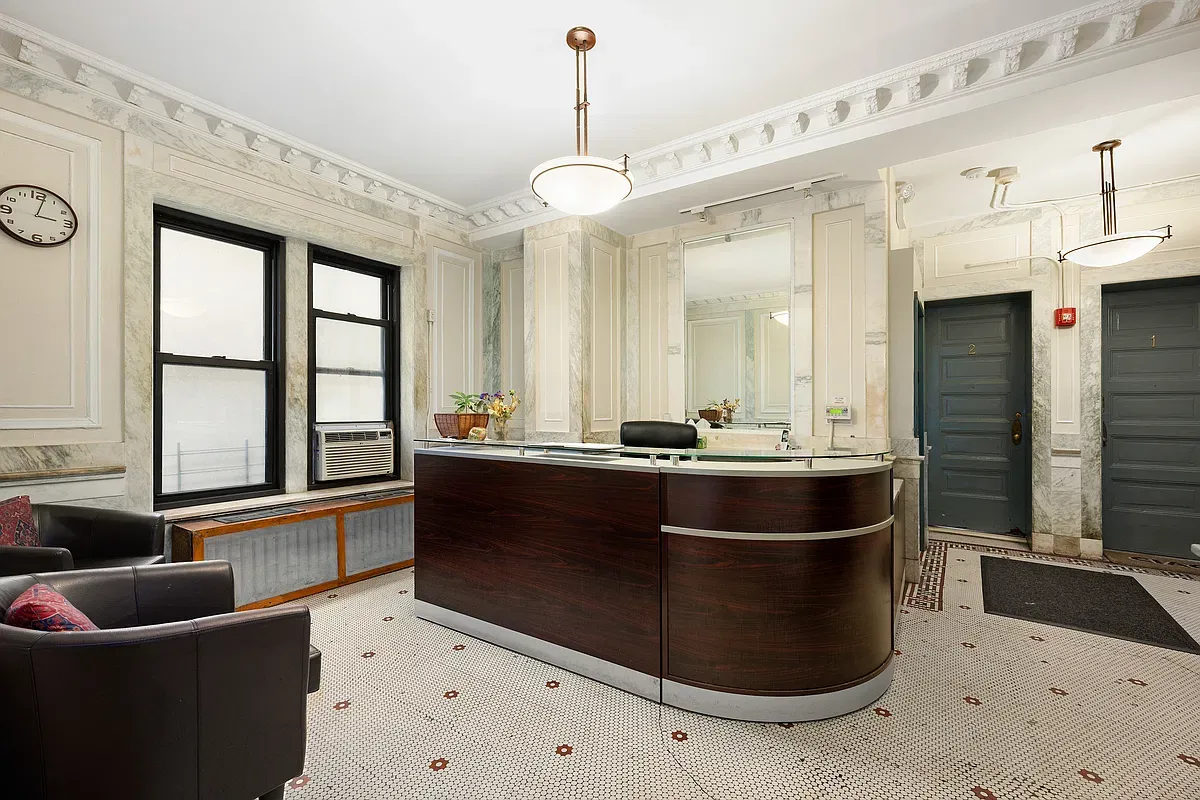 Prewar building lobby with attended desk at 523 West 121st Street