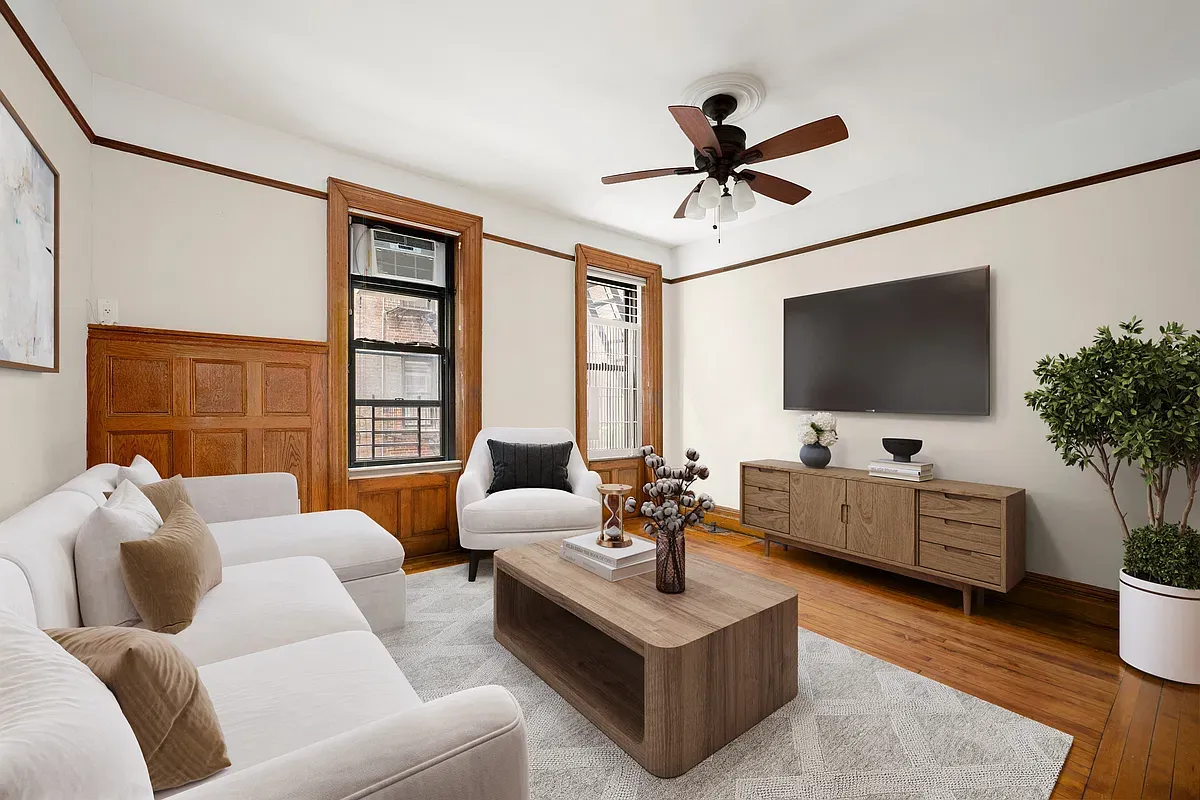 Virtually staged living room with ceiling fan and wood floors at 523 West 121st Street #2