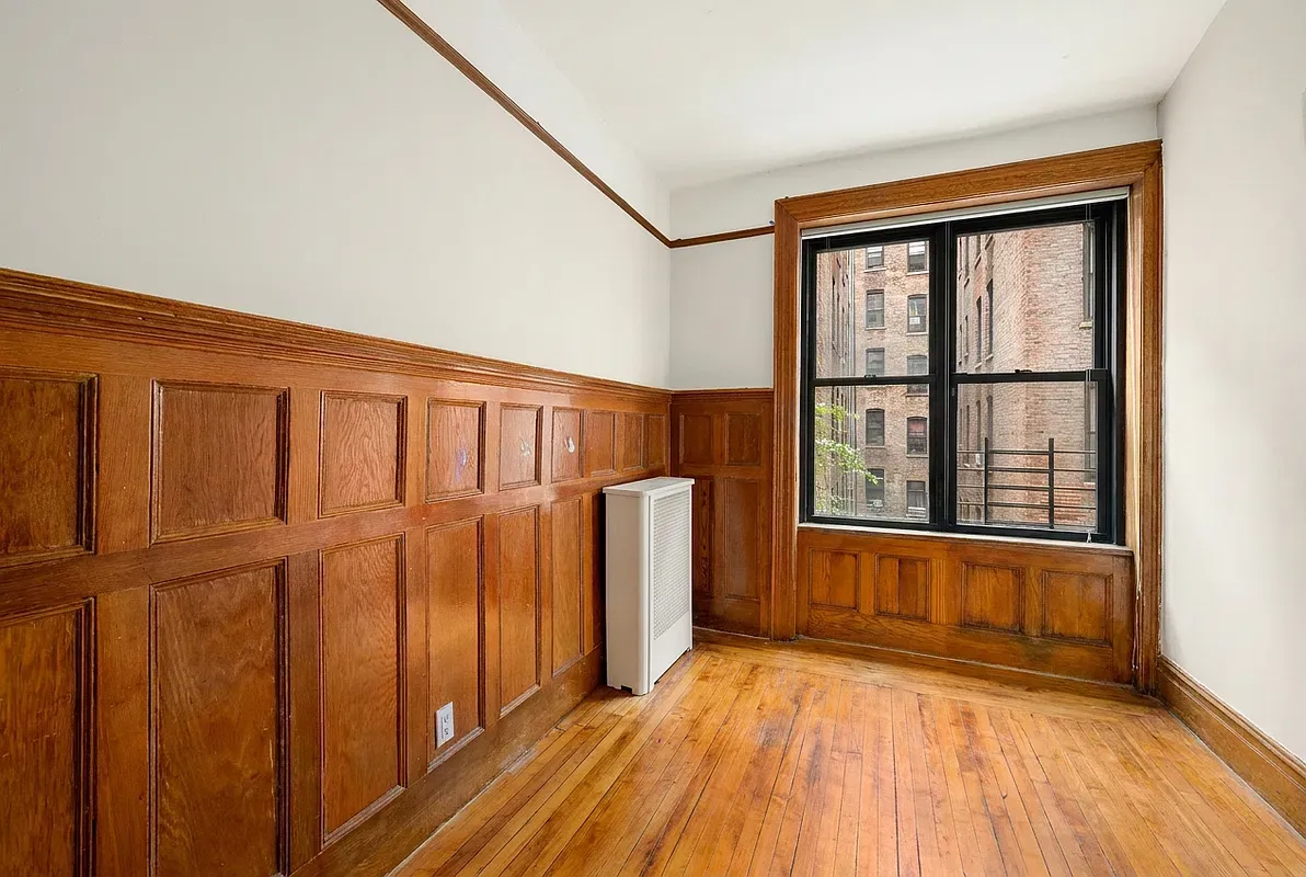 Room with original wood paneling at 523 West 121st Street #2