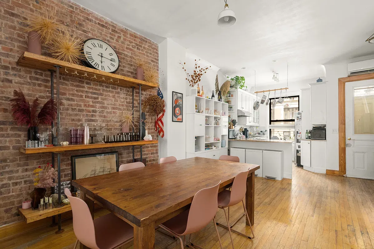 Dining room with exposed brick wall at 642 West 138th Street