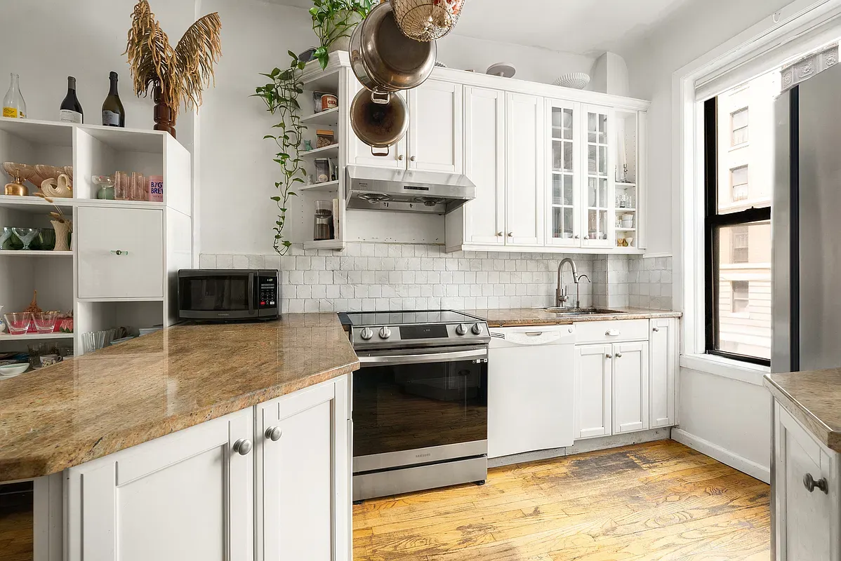 White kitchen with stainless appliances at 642 West 138th Street