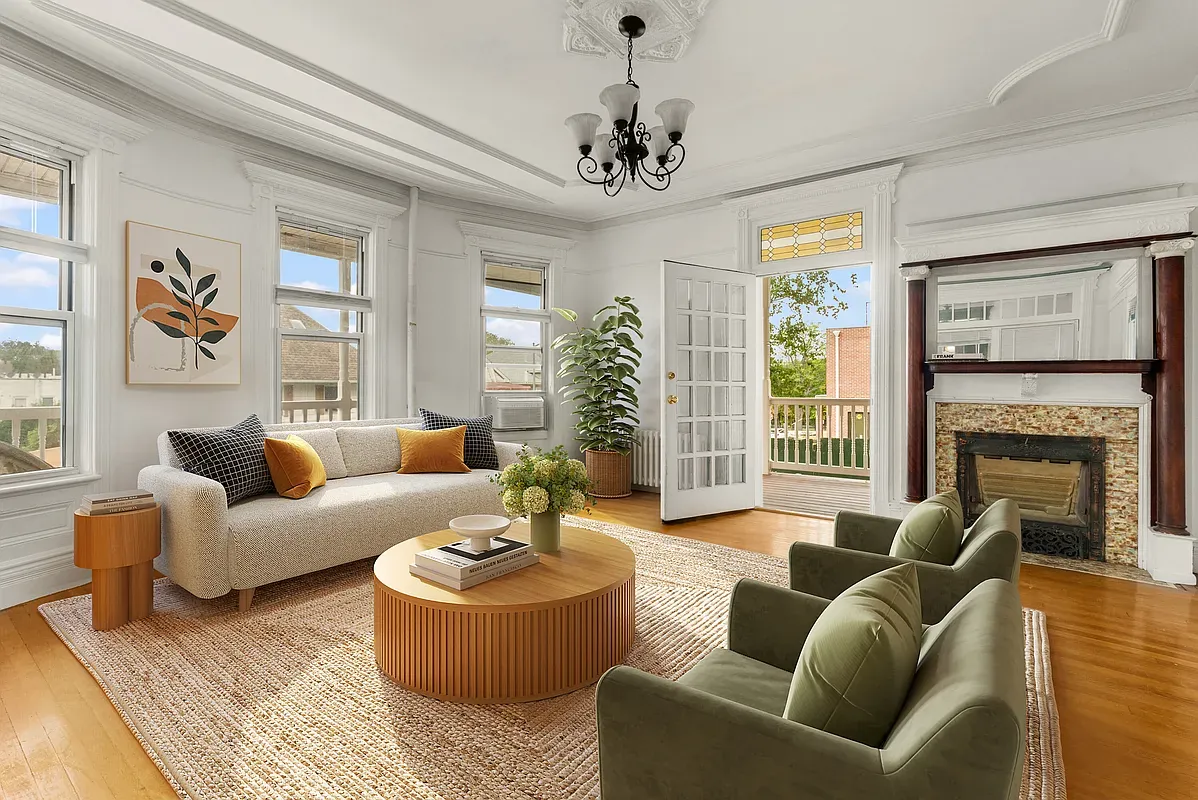 Virtually staged living room with fireplace and French doors at 6655 Sedgwick Place