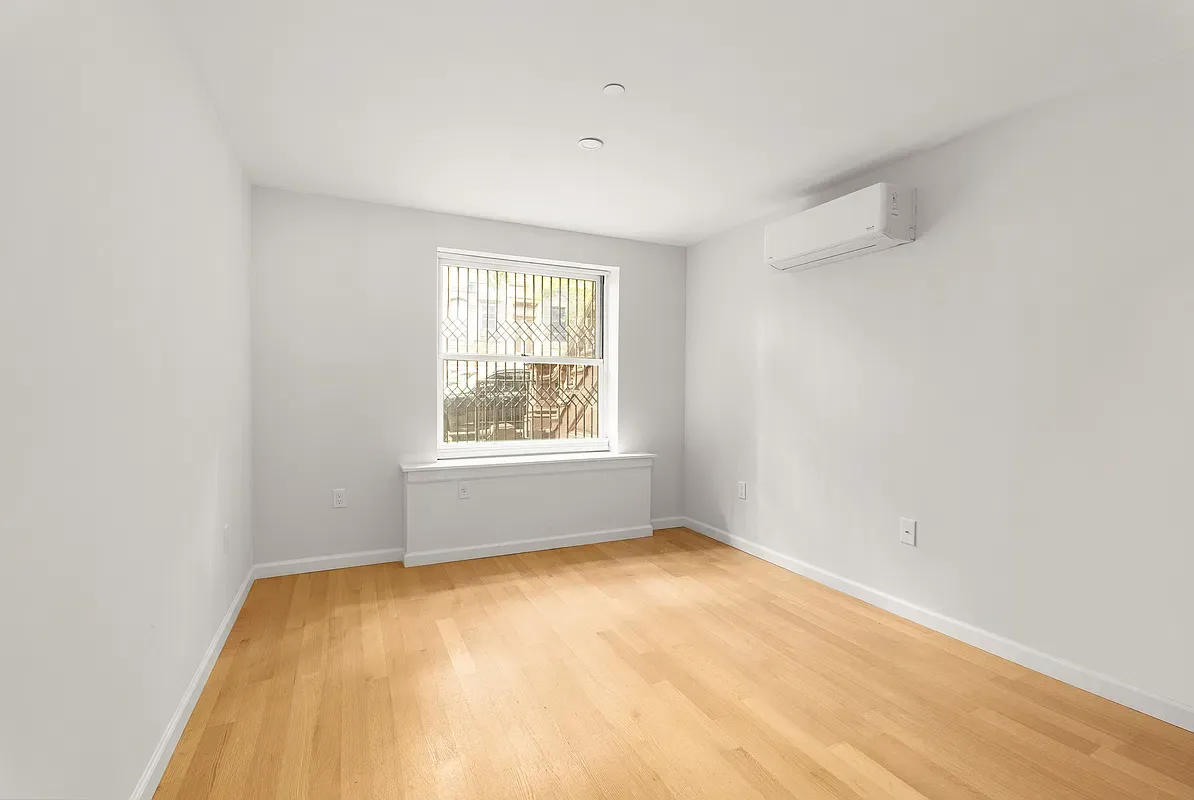 Bedroom with wood floors at 80 West 119th Street