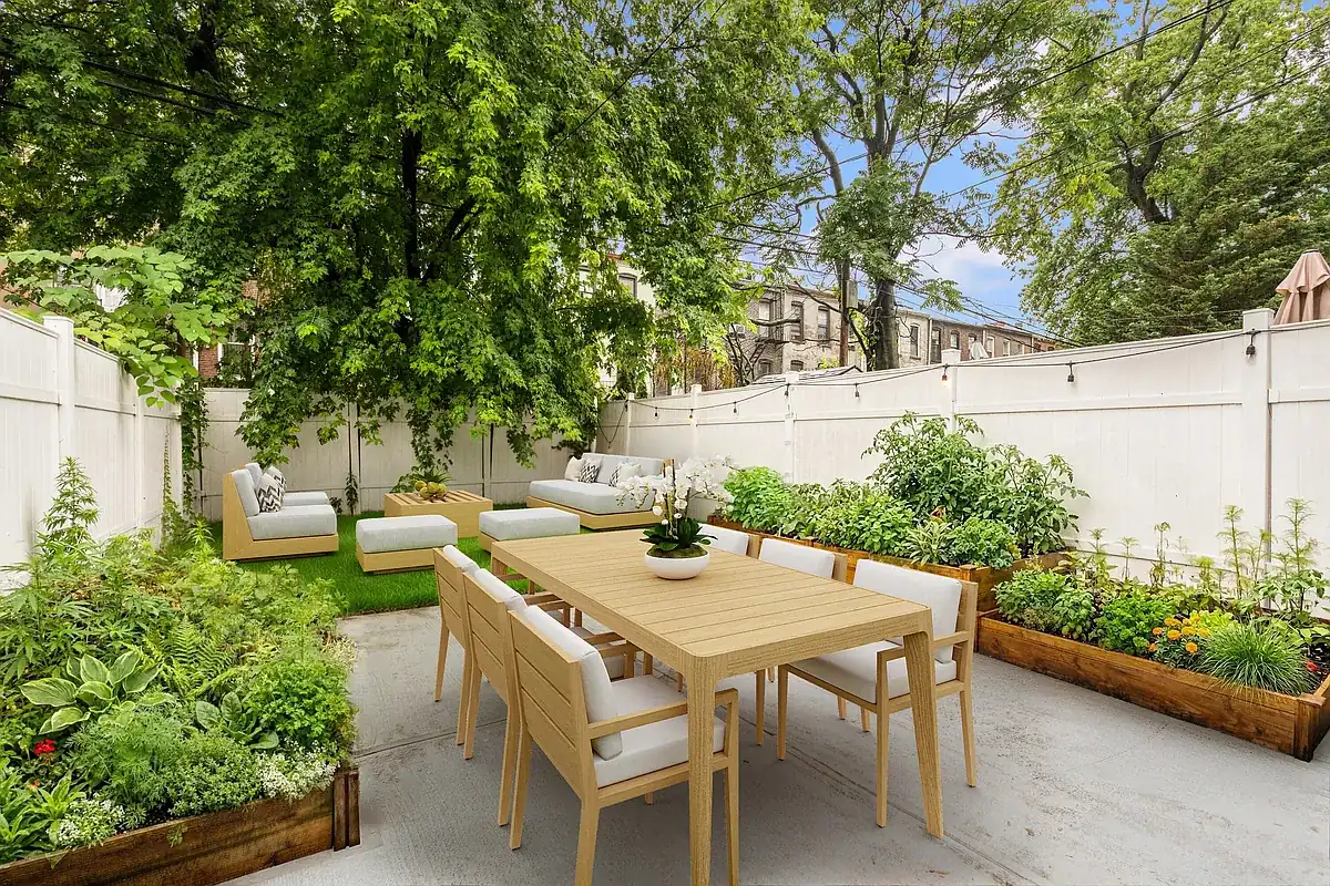 Virtually staged backyard patio with planters at 904 Gates Avenue