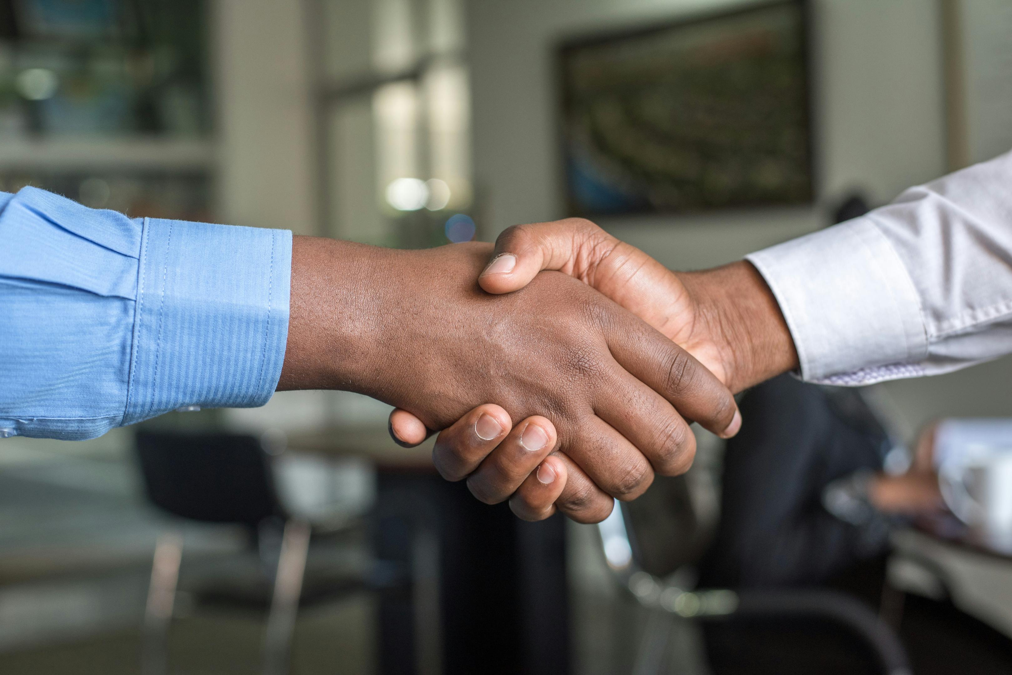 real estate consultation handshake between agent and client during home valuation or property advisory meeting